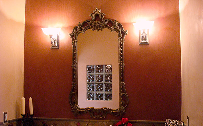 Interior venetian and redtop plaster behind a bathroom mirror