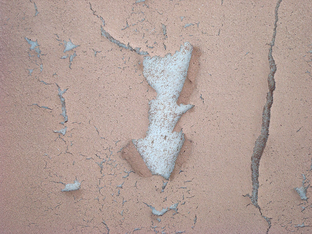 Severely cracked and peeling stucco