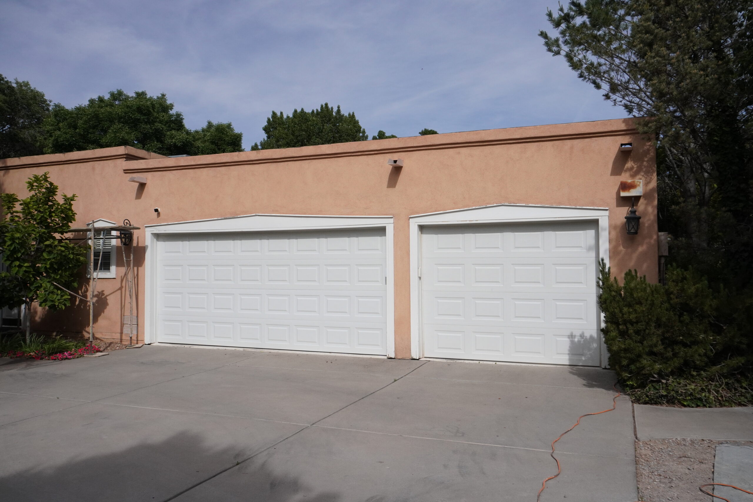 Two car garage of a flat-roofed home set to be restuccoed.
