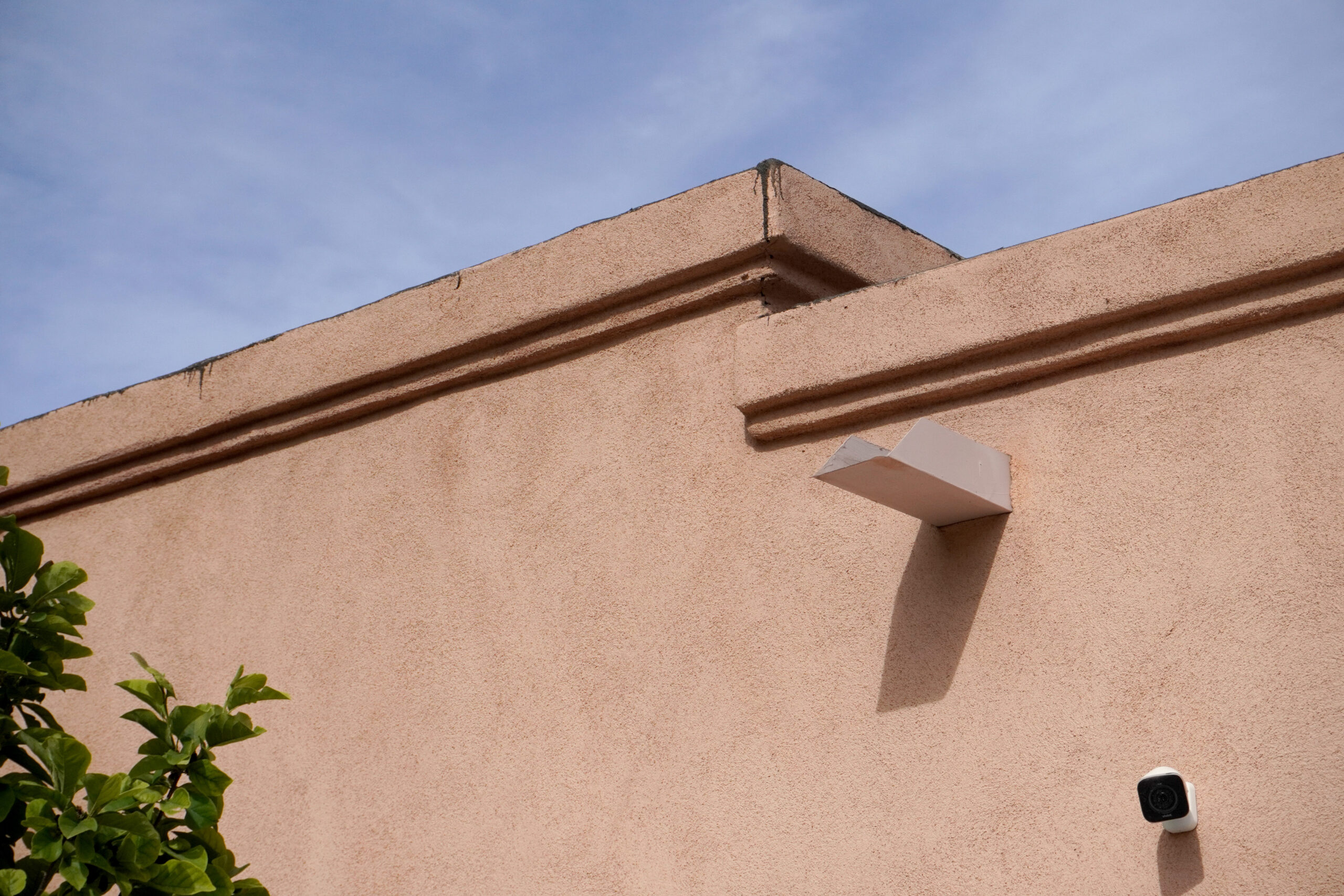 Damaged parapets of a flat-roofed home in New Mexico